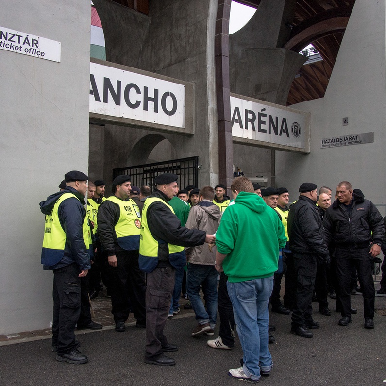 Fans of Ferencvarosi show their support as they hold scarves prior