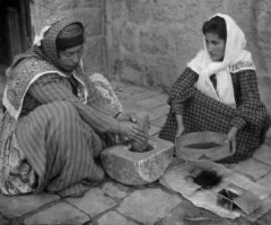 Palestinian women grinding coffee the old fashioned way, 1905