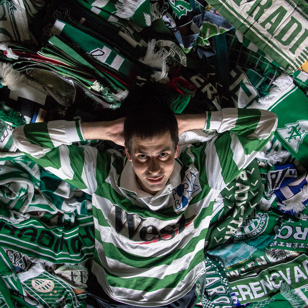 Fans of Ferencvarosi show their support as they hold scarves prior